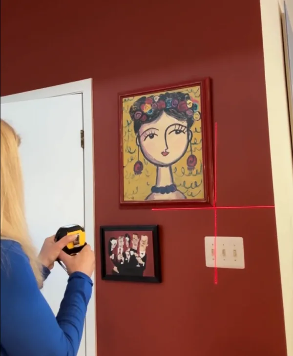 The Almighty Ruler projecting a straight laser alignment guide on a wall